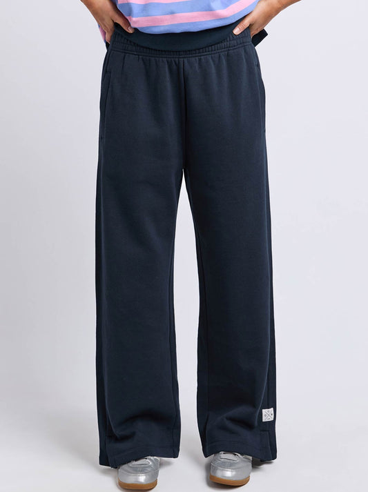 Image of a model wearing Pants. Product name - Elm Louise Trackpant in Navy colour by brand - Elm