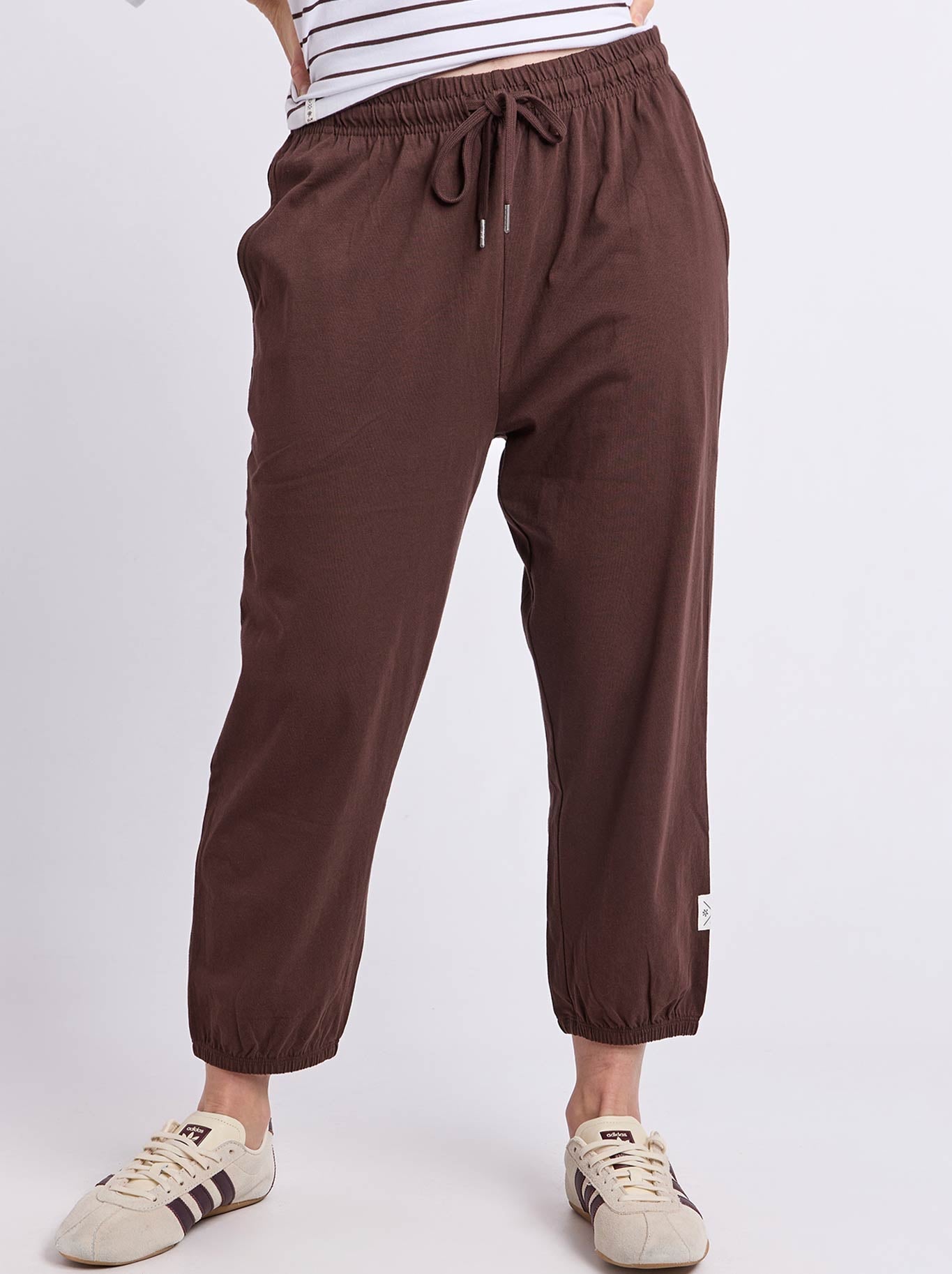 Image of a model wearing Pants. Product name - ELM ELLIE LOUNGE PANT in Coffee colour by brand - Elm