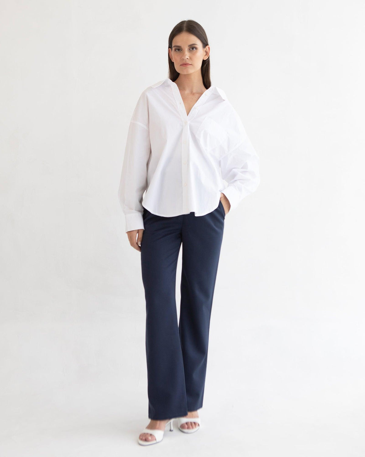 Image of a model wearing Pants. Product name - Emma Overbelly Straight Pants in colour by brand - Soon Maternity