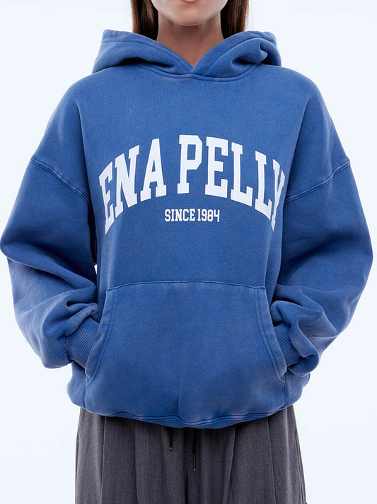 Image of a model wearing Outerwear. Productname: ENA PELLY EP VARSITY HOODIE in Indigo colour by brand - Ena Pelly