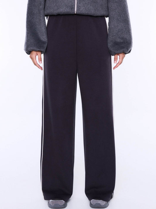 Image of a model wearing Pants. Product name - ENA PELLY ALESSIA RELAXED PANT in Char colour by brand - Ena Pelly