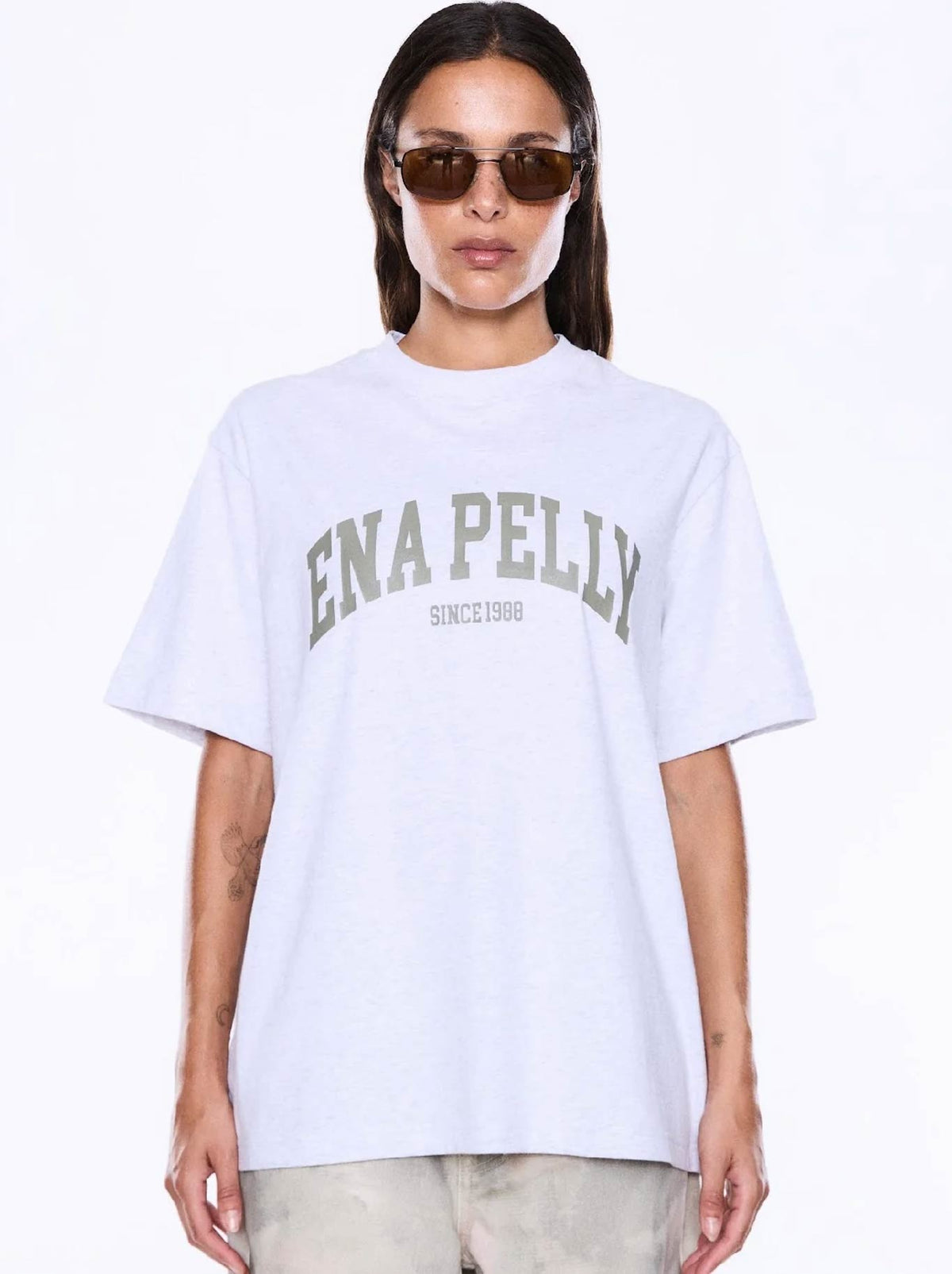 Image of a model wearing Tops. Product name - ENA PELLY SOPHIA RELAXED TEE in White Marle colour by brand - Ena Pelly