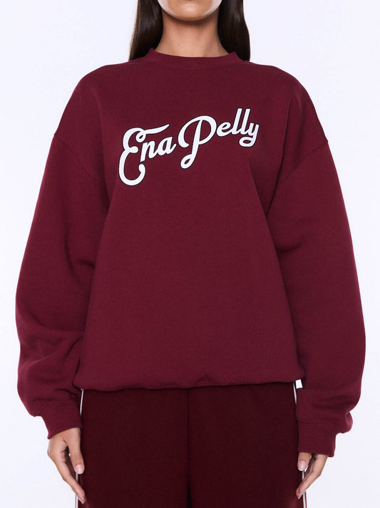 Image of a model wearing Tops. Product name - ENA PELLY MILA OVERSIZE SWEAT in Burgundy colour by brand - Ena Pelly