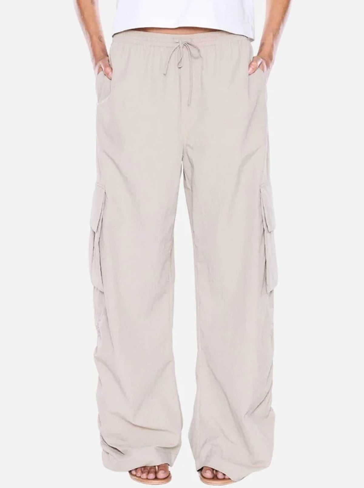 Image of a model wearing Pants. Product name - ENA PELLY RUE CARGO PANT in Sand colour by brand - Ena Pelly
