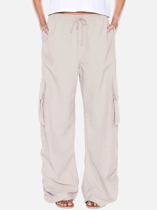 Image of a model wearing Pants. Product name - ENA PELLY RUE CARGO PANT in Sand colour by brand - Ena Pelly