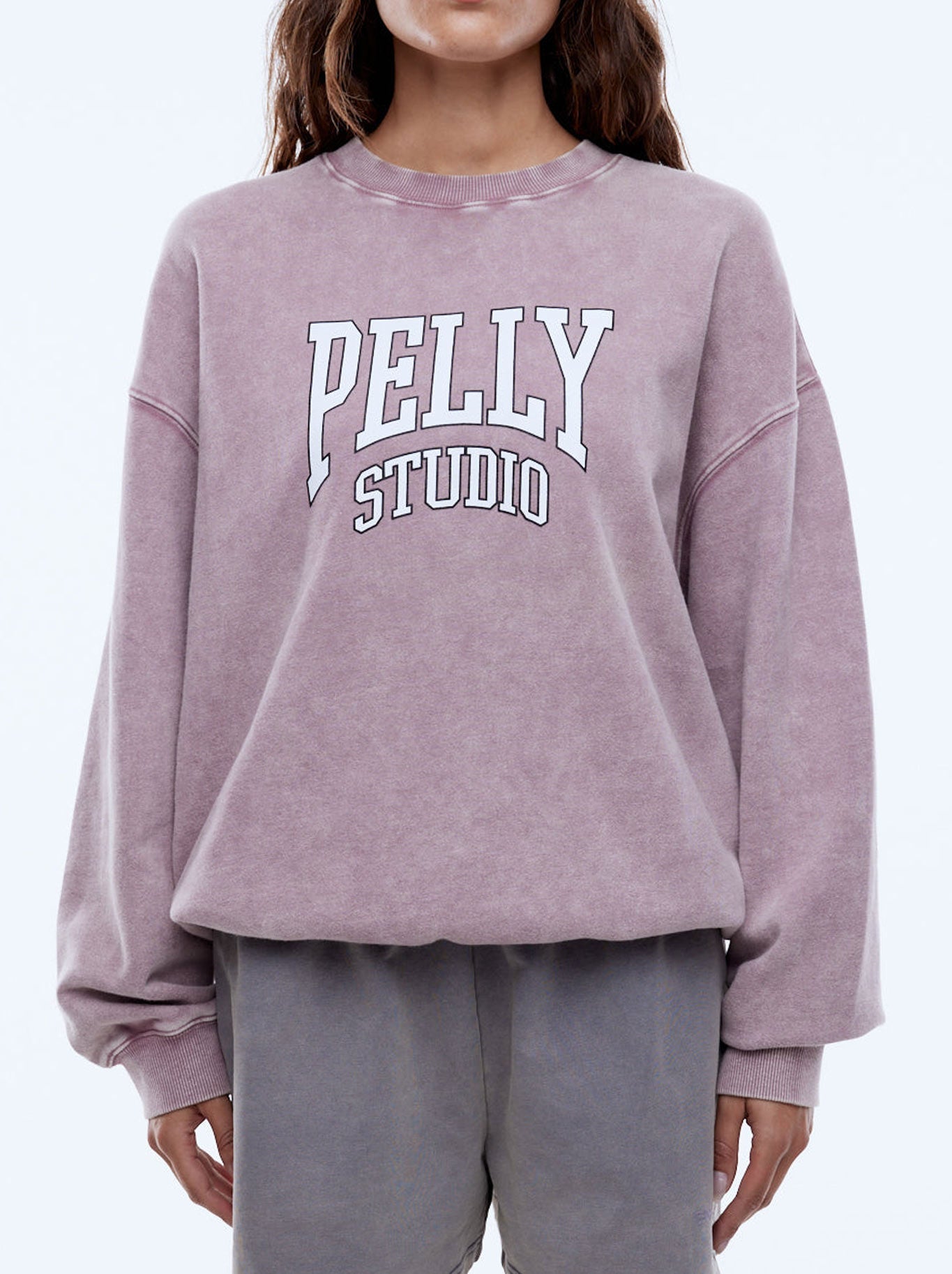 Image of a model wearing Outerwear. Productname: ENA PELLY PELLY STUDIO SWEATSHIRT in Vintage Rose colour by brand - Ena Pelly