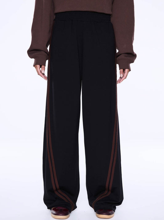 Image of a model wearing Pants. Product name - ENA PELLY VALENTINA STRIPE PANT in Black/Brown colour by brand - Ena Pelly