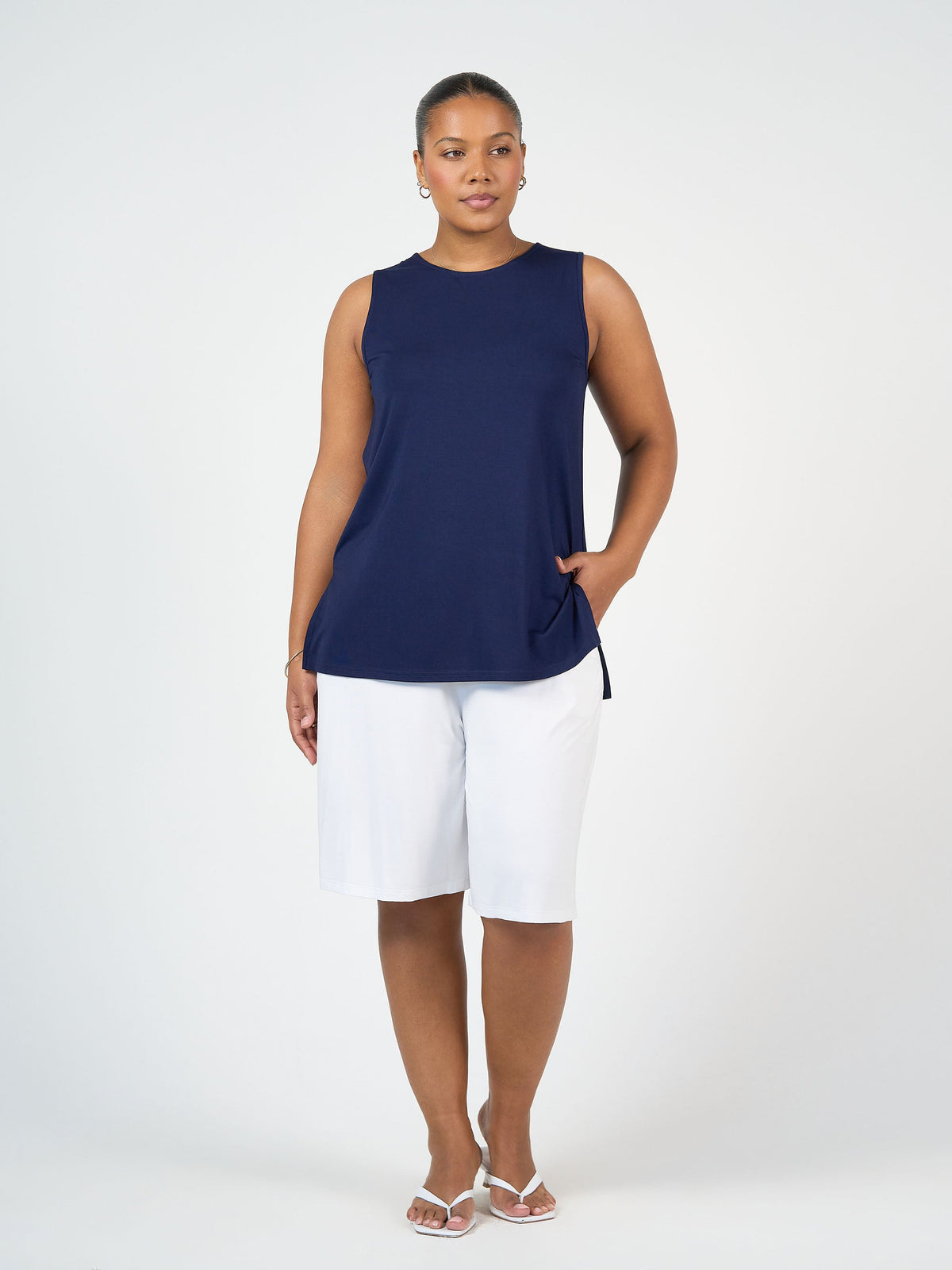 Image of a model wearing Tops. Product name - Fantasia Bamboo Tunic Top Navy in Navy colour by brand - Lou Lou