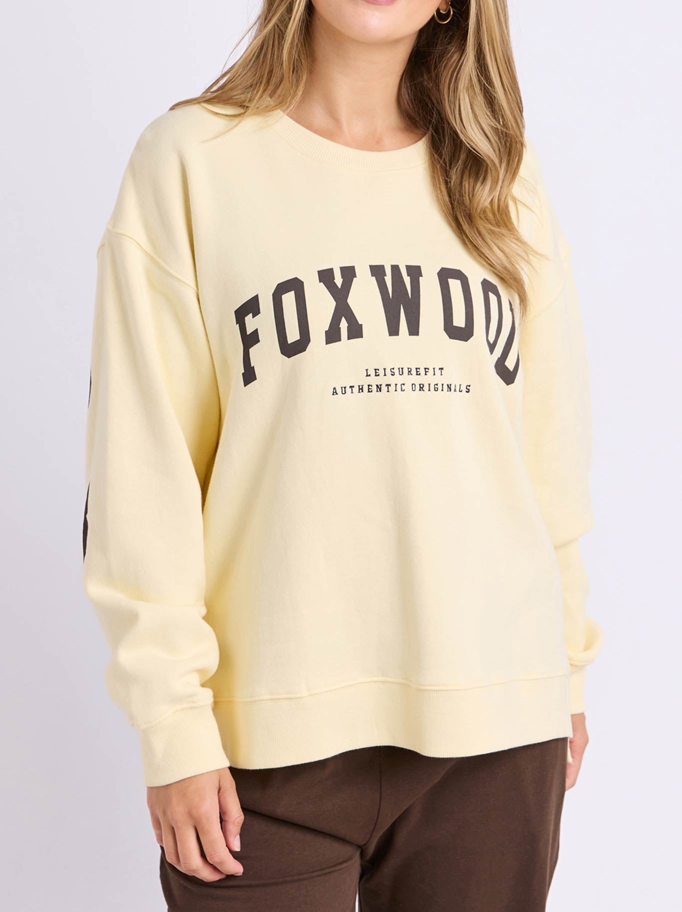 Image of a model wearing Tops. Product name - FOXWOOD INTERVAL CREW in Buttercream/Choc colour by brand - Foxwood