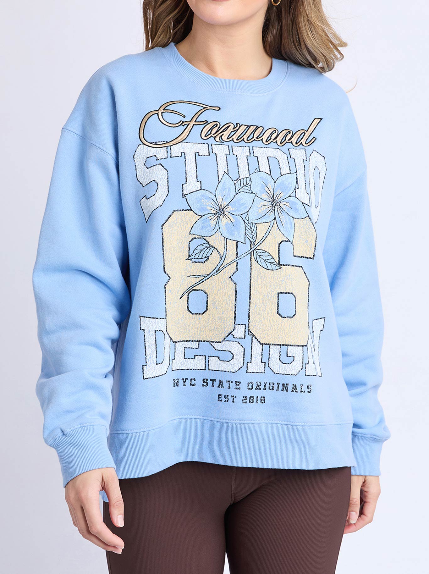 Image of a model wearing Tops. Product name - Foxwood Floral Club Crew in Blue colour by brand - Foxwood