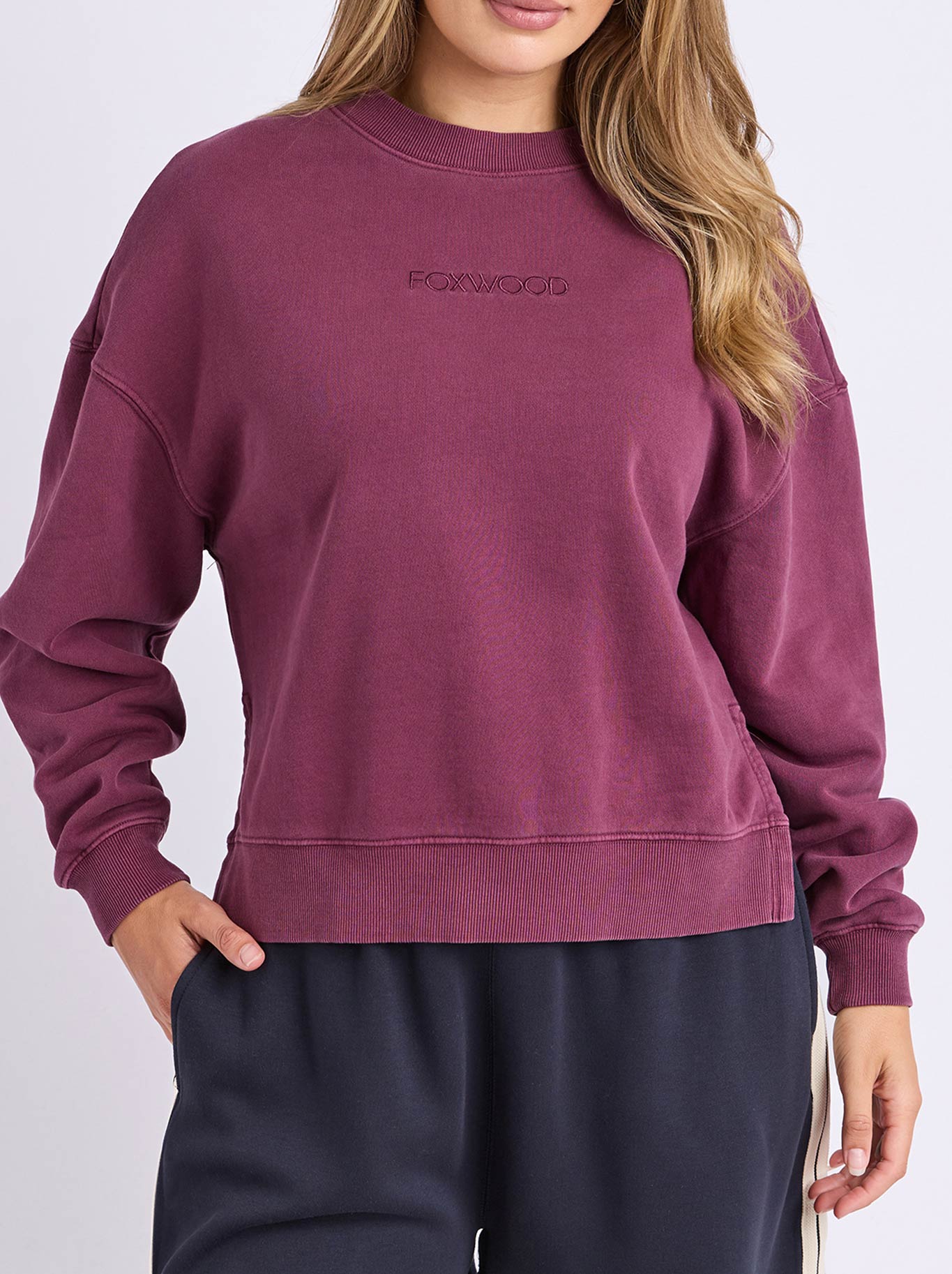 Image of a model wearing Tops. Product name - Foxwood Essence Crew in Plum colour by brand - Foxwood