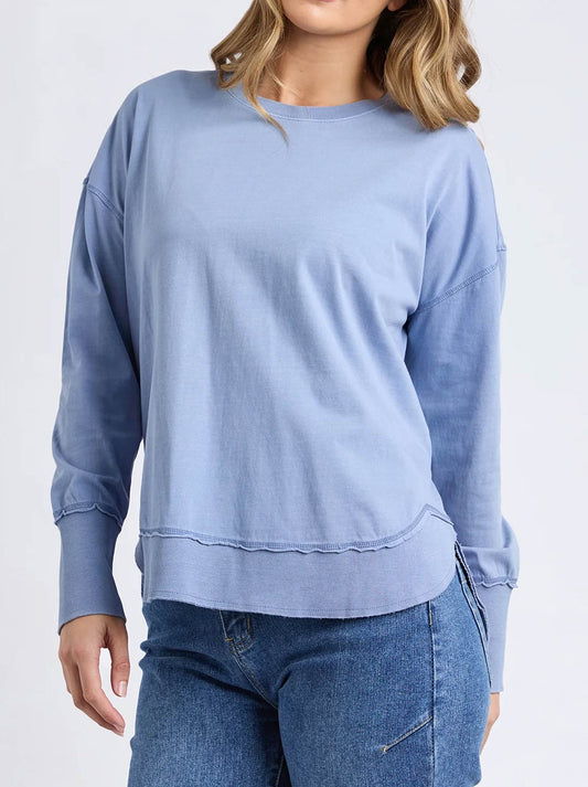 Image of a model wearing Tops. Product name - FOXWOOD FARRAH LONG SLEEVE in Country Blue colour by brand - Foxwood