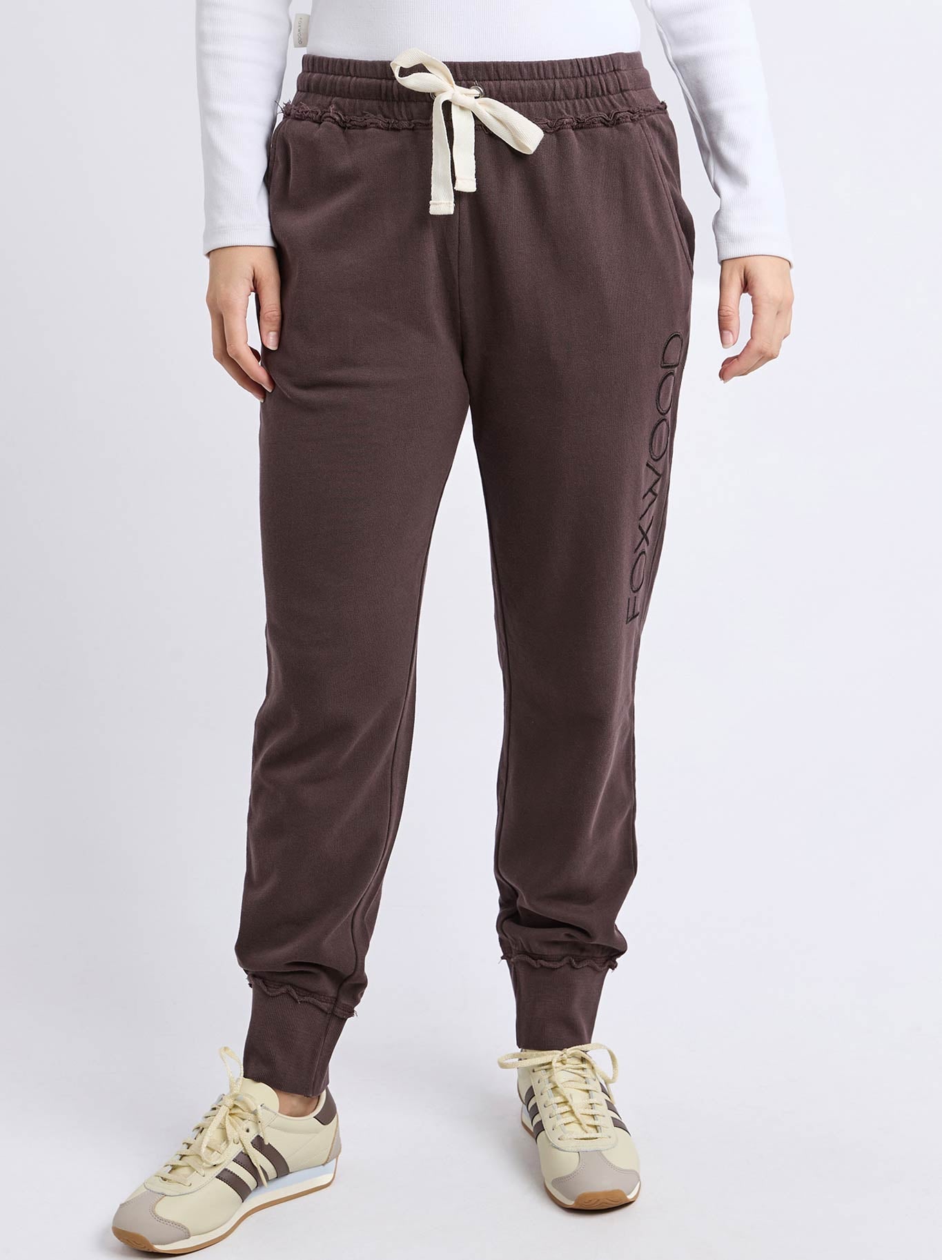 Image of a model wearing Pants. Product name - Foxwood Simplified Trackpant in Coffee colour by brand - Foxwood