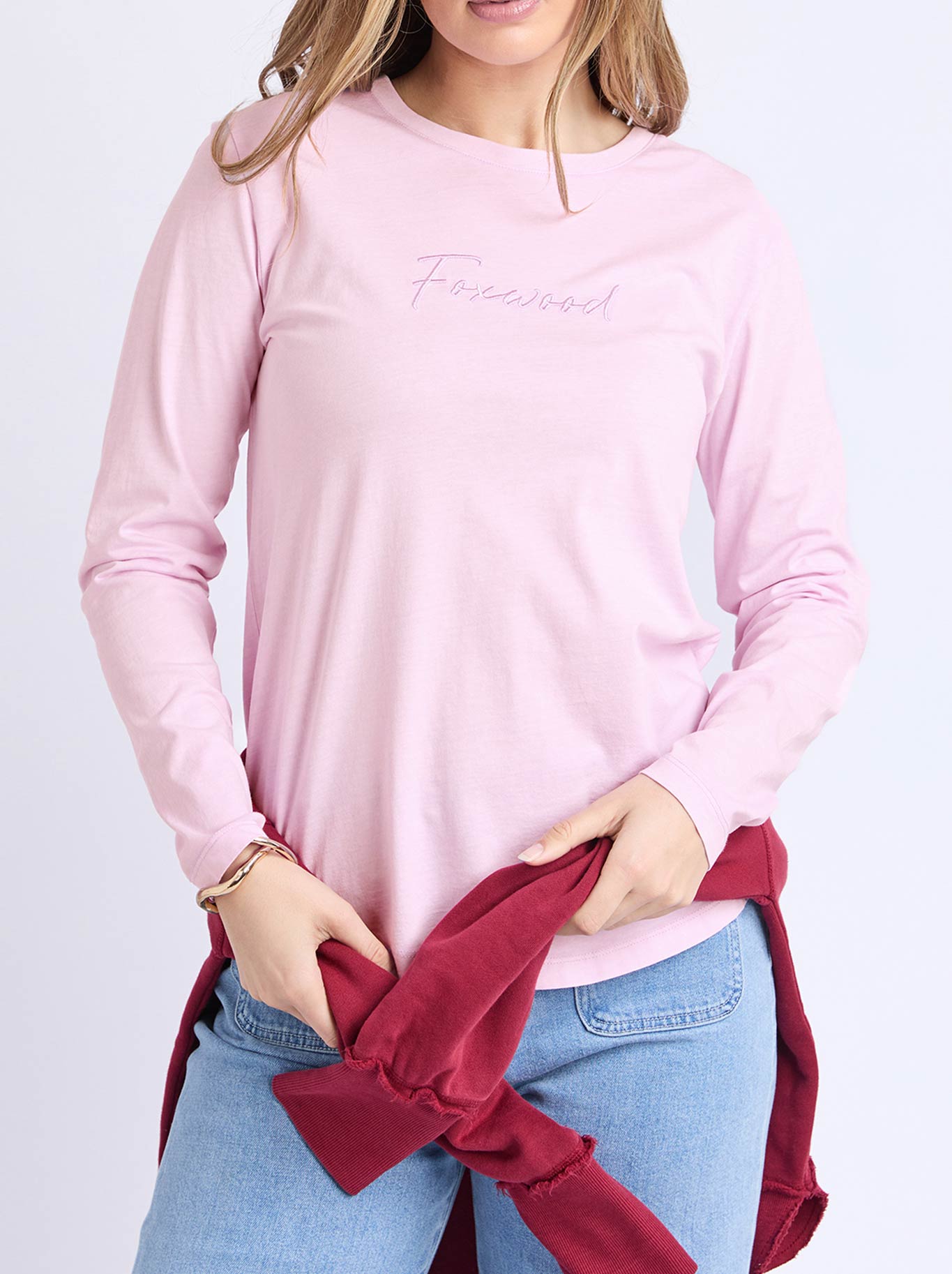 Image of a model wearing Tops. Product name - FOXWOOD SIGNATURE LONG SLEEVE TEE in Ballerina colour by brand - Foxwood