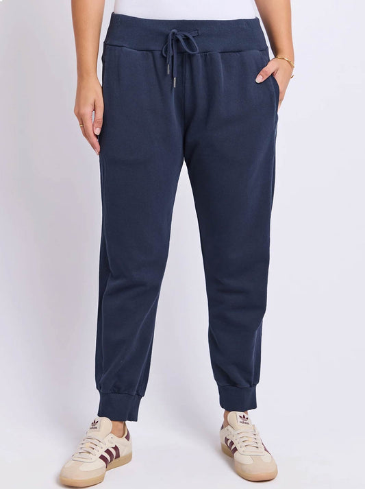 Image of a model wearing Pants. Product name - FOXWOOD SAMI TRACKPANT in Dark Sapphire colour by brand - Foxwood