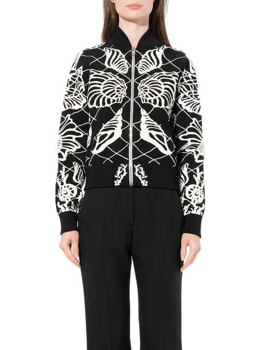 Image of a model wearing Outerwear. Productname: ALEXANDER MCQUEEN Bomber Jacket in Black Ivory colour by brand - ALEXANDER MCQUEEN