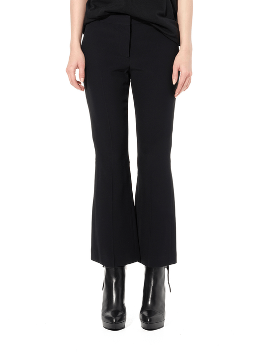 Image of a model wearing Pants. Productname: ALEXANDER MCQUEEN Leaf Eye Kick Pants in Black colour by brand - ALEXANDER MCQUEEN
