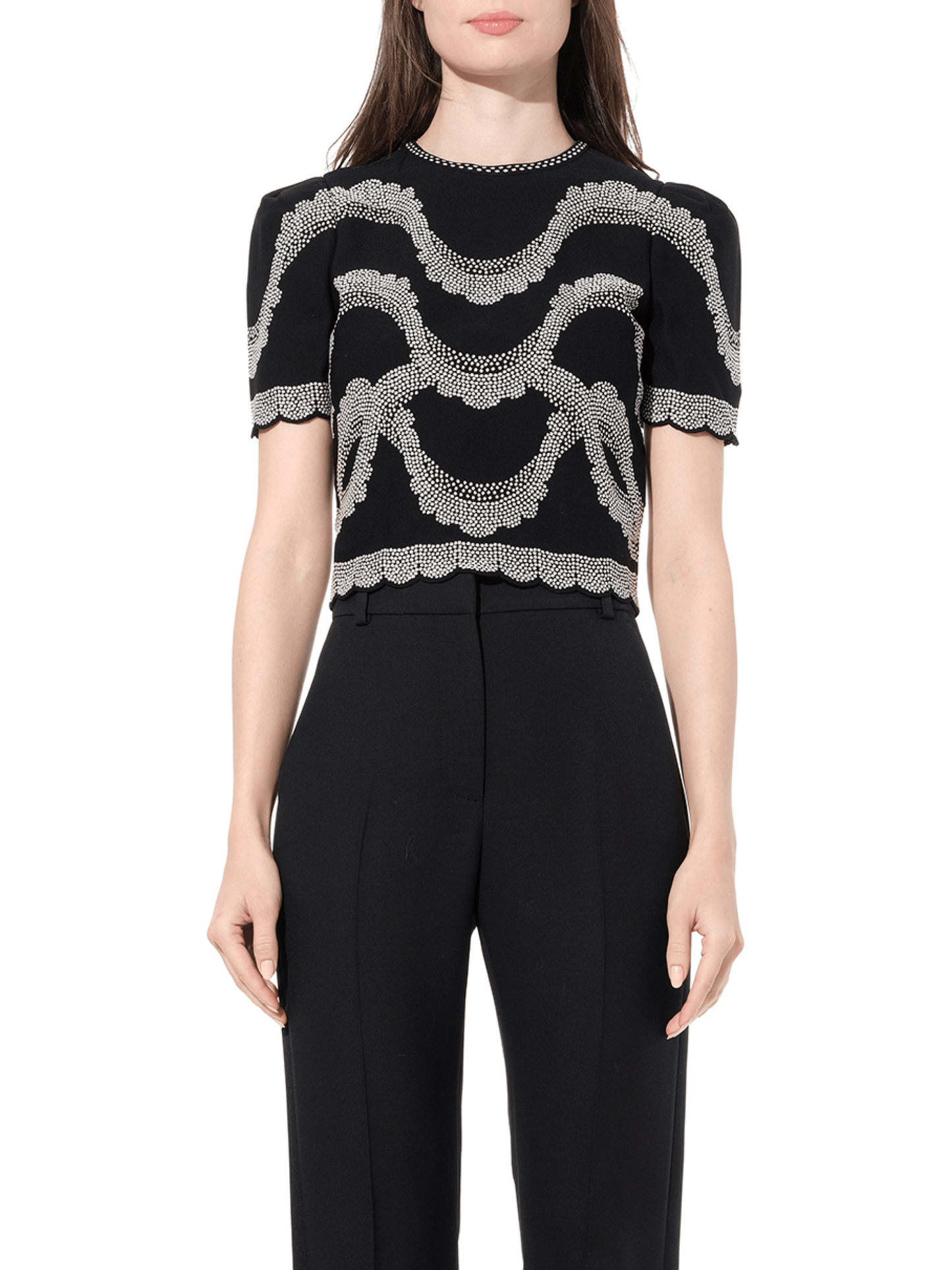 Image of a model wearing Shorts. Productname: ALEXANDER MCQUEEN Short Sleeve Top in Black colour by brand - ALEXANDER MCQUEEN