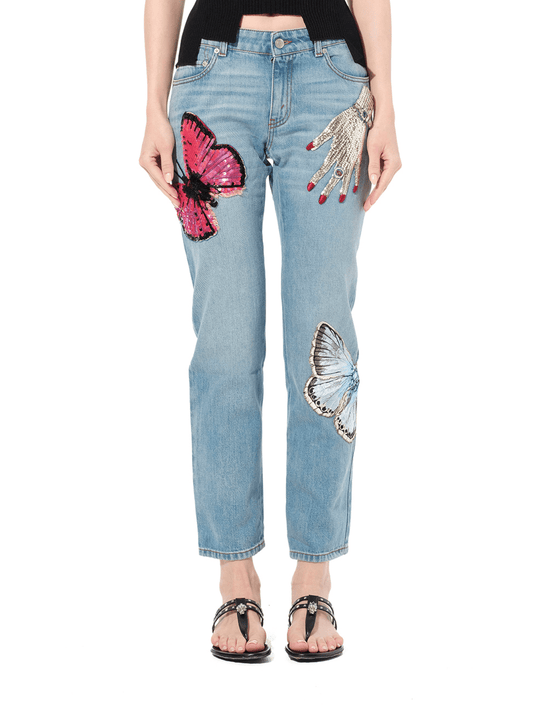 Image of a model wearing Denim. Productname: ALEXANDER MCQUEEN Denim Pants with Print in BLUE colour by brand - ALEXANDER MCQUEEN