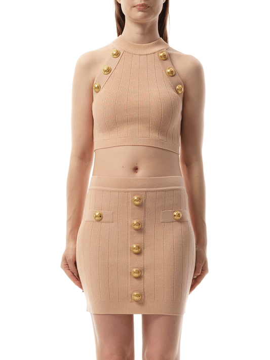 Image of a model wearing Tops. Productname: BALMAIN 6 Button Halterneck Knit Cropped Top in Nude Rose colour by brand - BALMAIN