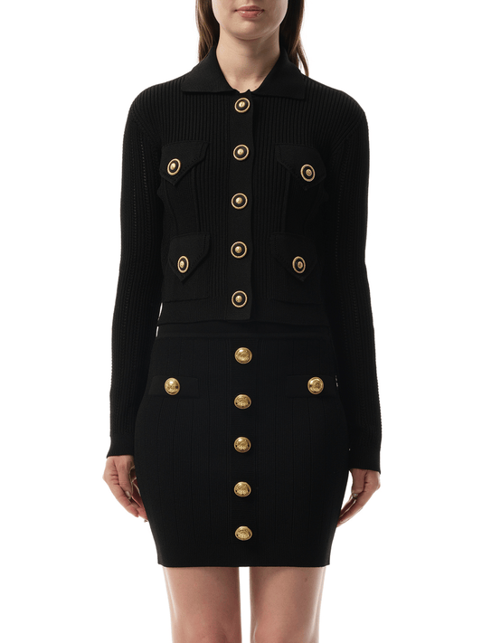 Image of a model wearing Outerwear. Productname: BALMAIN 4 Pockets Buttoned Ribbed Knit Cardigan in BLACK colour by brand - BALMAIN