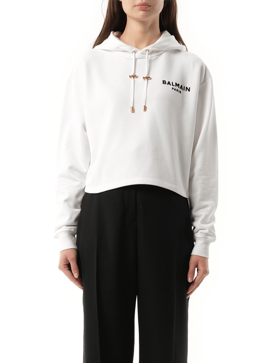 Image of a model wearing Outerwear. Productname: BALMAIN Balmain Flock Detail Cropped Hoodie in White Black colour by brand - BALMAIN