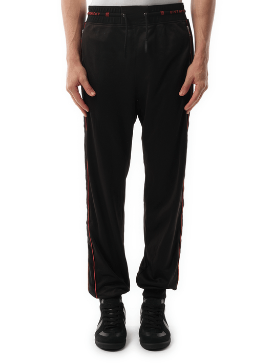 Image of a model wearing Pants. Product name - Jogging Pants Black in Black colour by brand - GIVENCHY