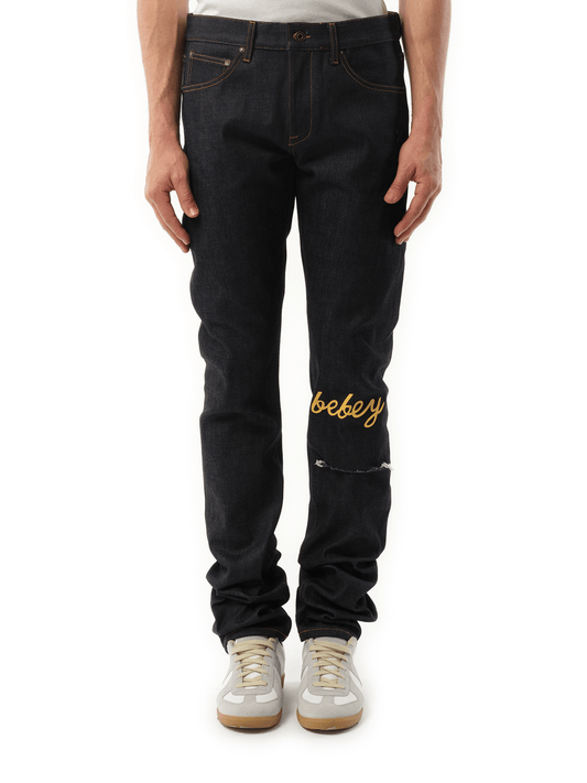 Image of a model wearing Denim. Productname: OFF-WHITE THL Bebey Arrow Selvedge Jeans in BLUE colour by brand - OFF-WHITE