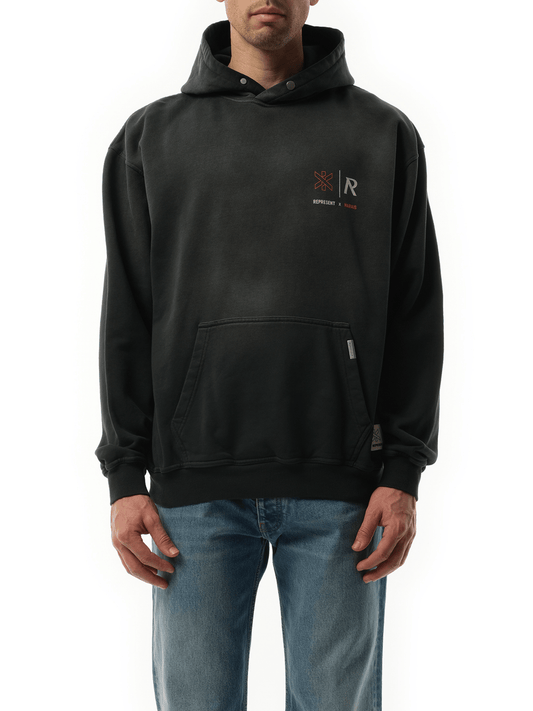Image of a model wearing Outerwear. Product name - Represent x Marais Logo Lock Up Hoodie in Black colour by brand - REPRESENT