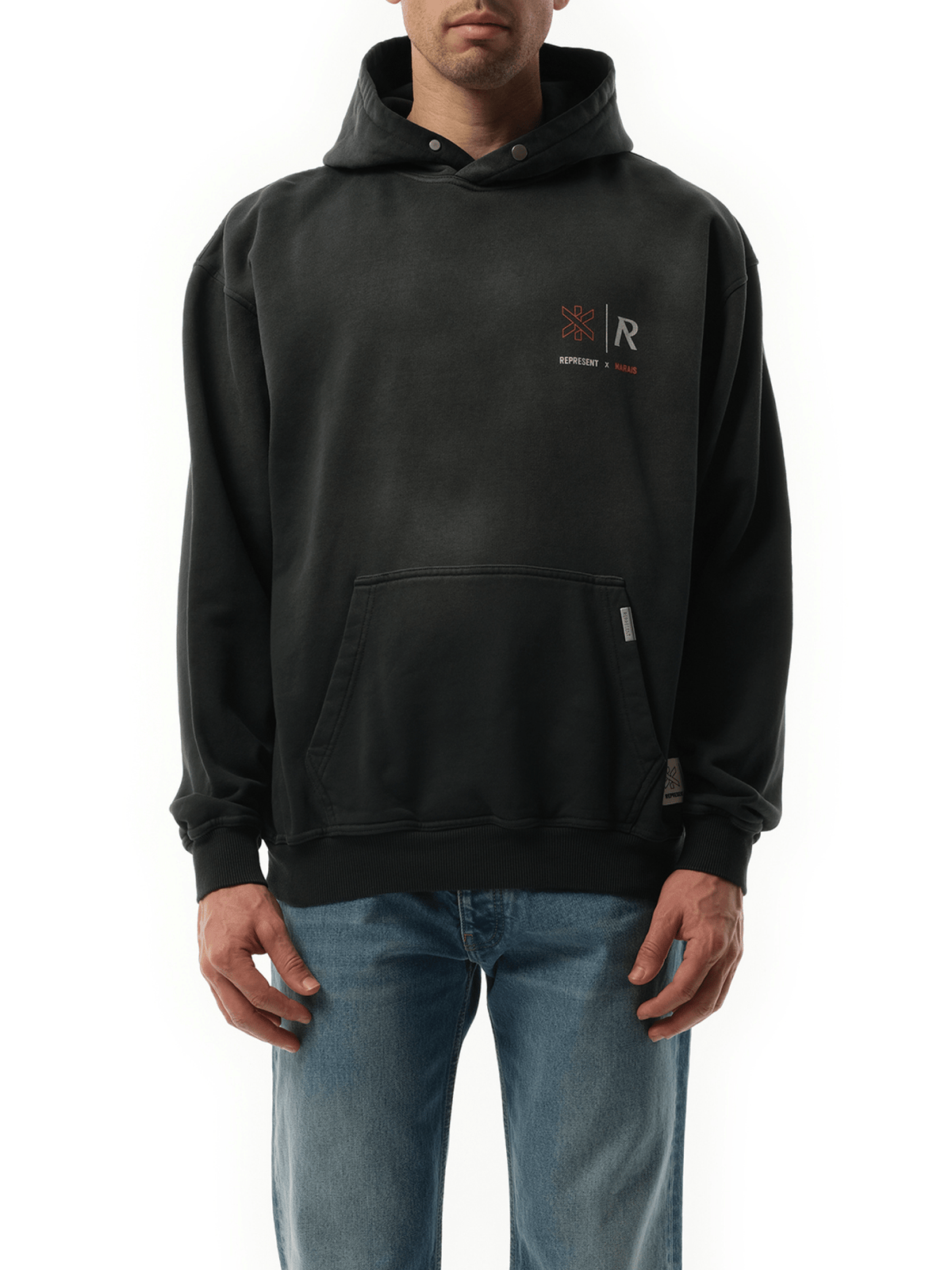 Image of a model wearing Outerwear. Product name - Represent x Marais Logo Lock Up Hoodie in Black colour by brand - REPRESENT