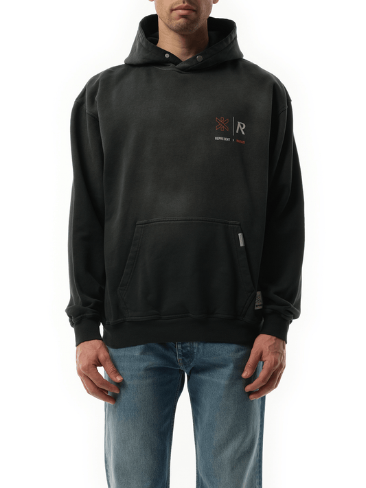 Image of a model wearing Outerwear. Productname: Represent x Marais Logo Lock Up Hoodie in Black colour by brand - REPRESENT