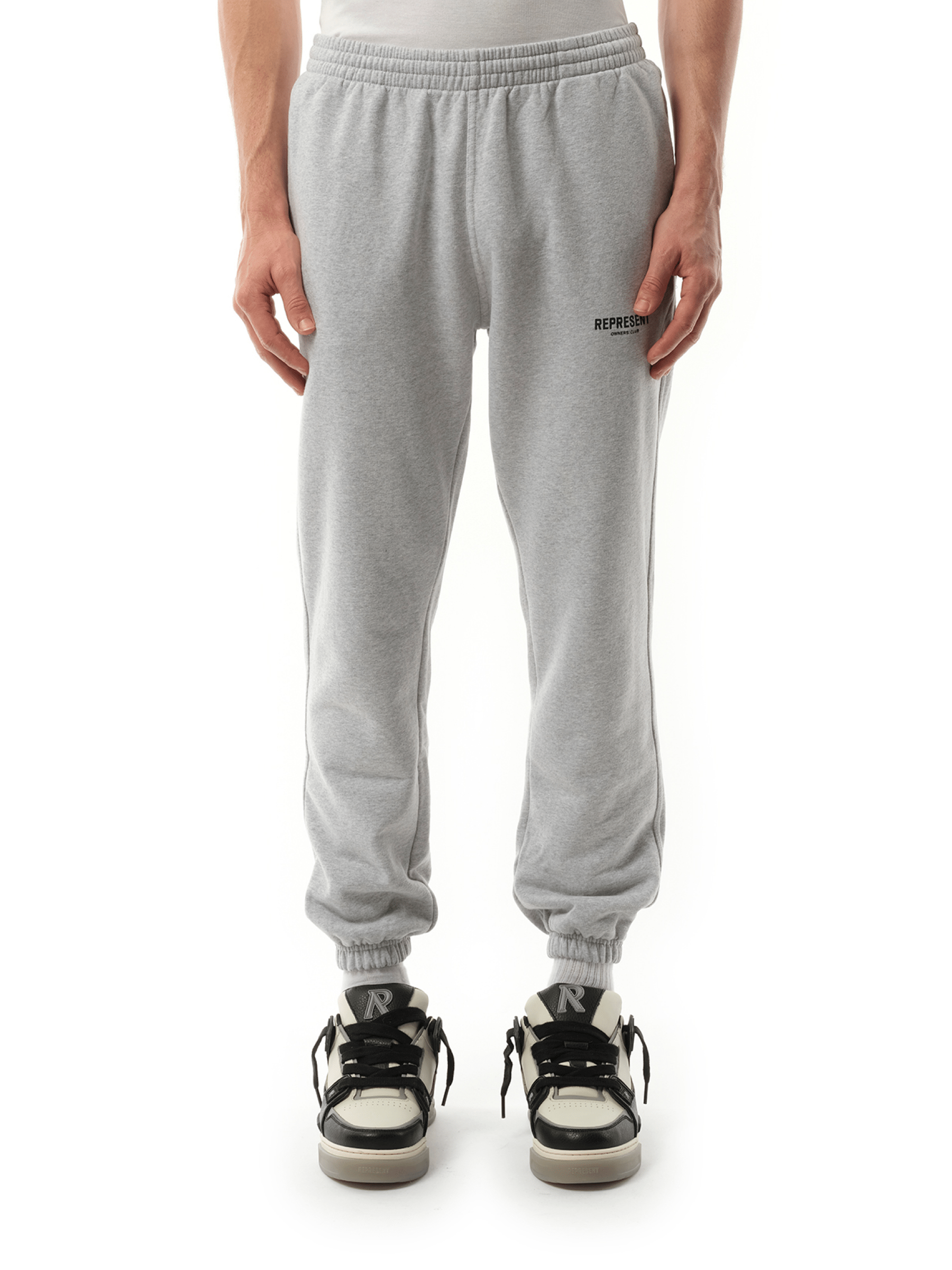 Image of a model wearing Pants. Product name - Represent Owners Club Sweatpants in Grey colour by brand - REPRESENT