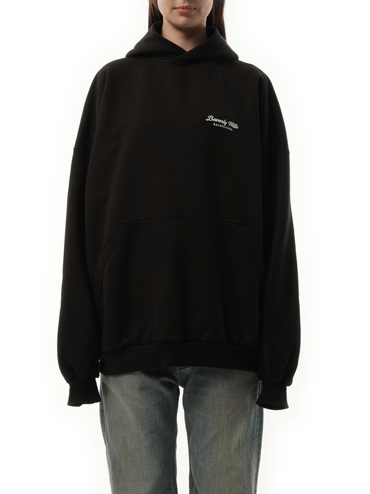 Image of a model wearing Outerwear. Productname: BALENCIAGA Beverly Hills Large Fit Hoodie in Washed Black colour by brand - BALENCIAGA