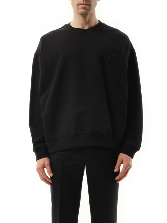 Image of a model wearing Outerwear. Product name - PariSeoul Sweatshirt in Black colour by brand - WOOYOUNGMI