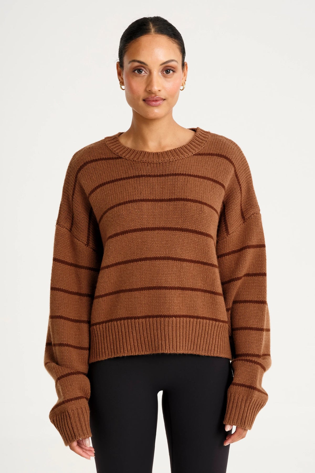 Image of a model wearing Outerwear. Product name - ALLFENIX Stripe Crew Neck Knit in Espresso colour by brand - All Fenix