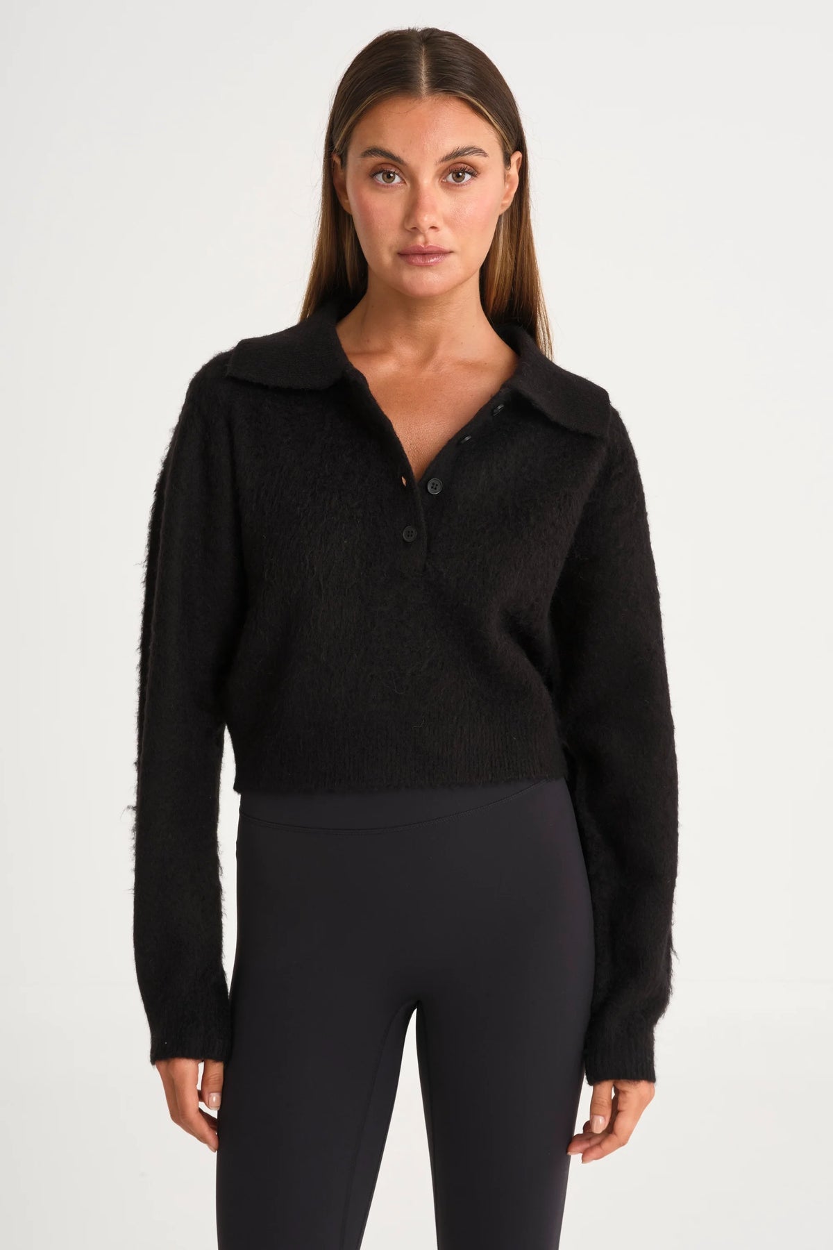 Image of a model wearing Outerwear. Product name - 1/2 Button Polo Knit in Black colour by brand - All Fenix