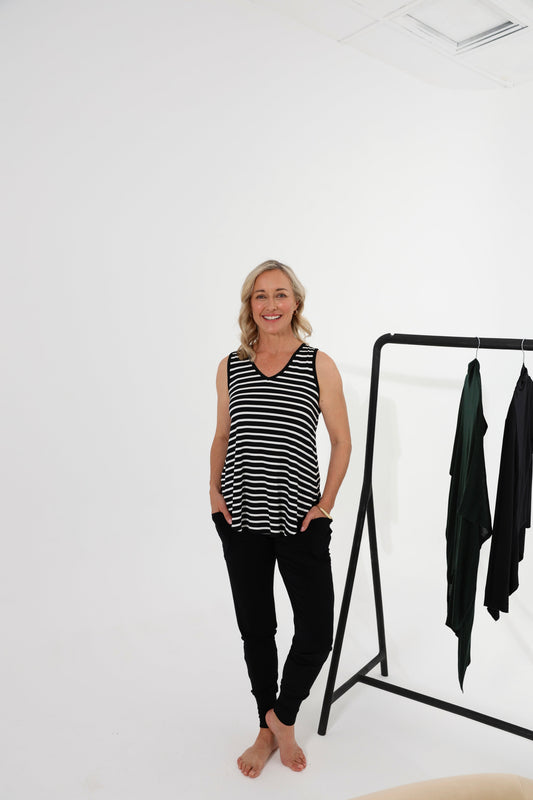 Image of a model wearing Pants. Product name - Gaga Bamboo Cuffed Sweat Pant in Black colour by brand - Lou Lou