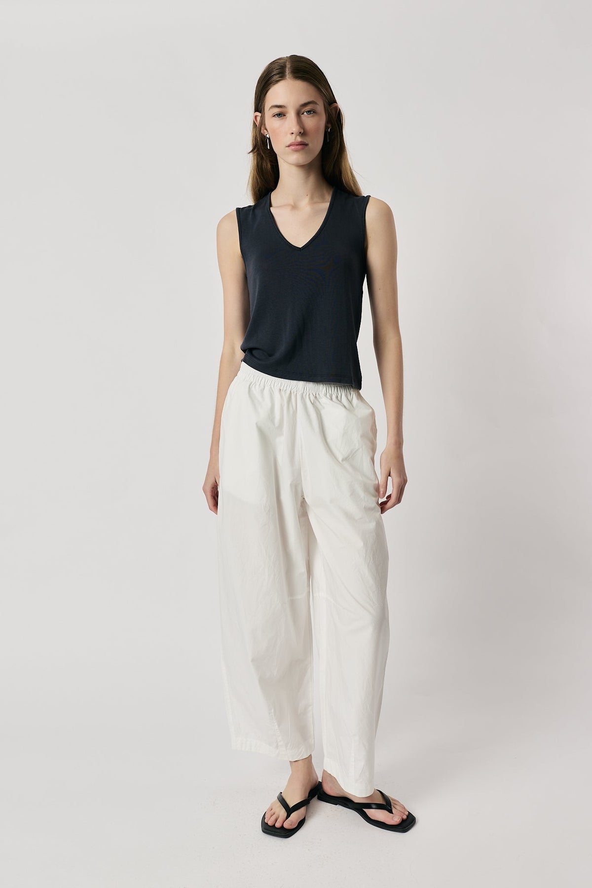 Image of a model wearing Pants. Product name - Giliann Agnes Pant White in White colour by brand - Giliann