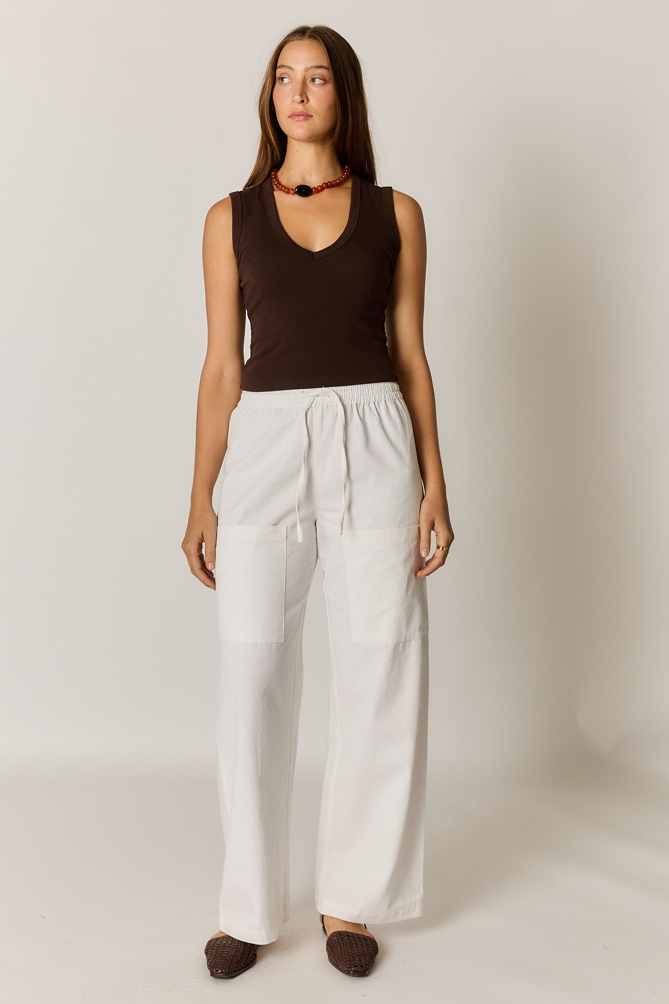 Image of a model wearing Pants. Product name - Giliann Alma Pocket Pant White in White colour by brand - Giliann
