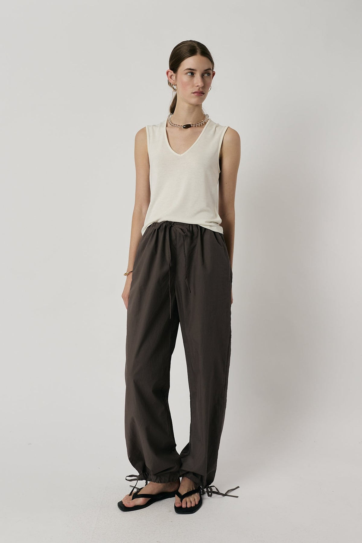 Image of a model wearing Pants. Product name - Giliann Axel Pant Charcoal in Charcoal colour by brand - Giliann