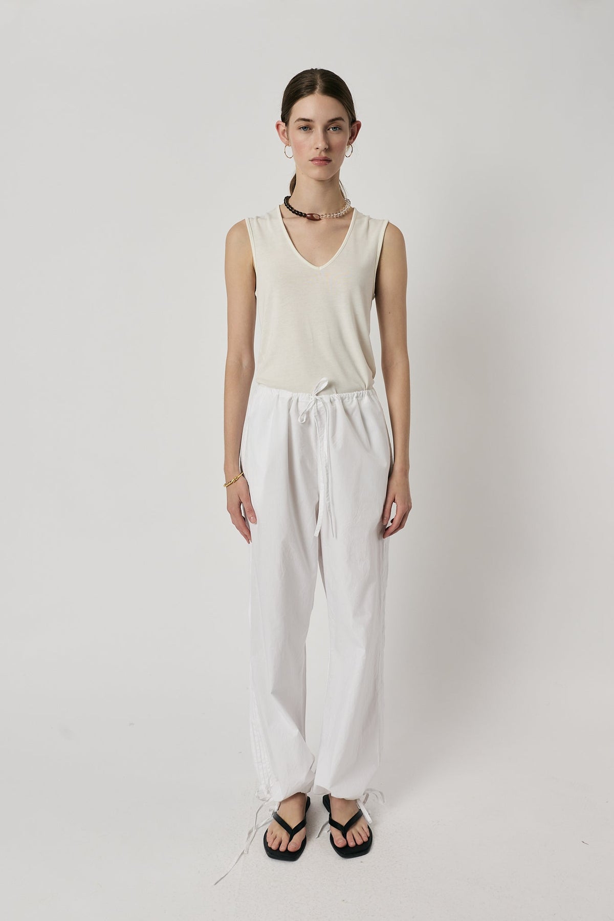 Image of a model wearing Pants. Product name - Giliann Axel Pant White in White colour by brand - Giliann