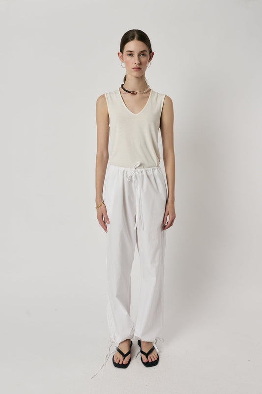 Image of a model wearing Pants. Product name - Giliann Axel Pant White in White colour by brand - Giliann