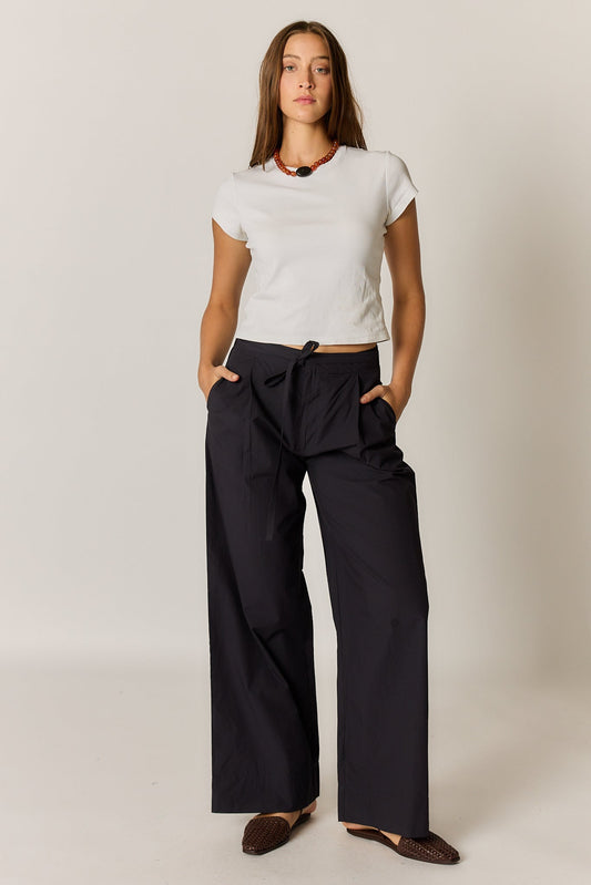 Image of a model wearing Pants. Product name - Giliann Floyd Tie Pant Black in Black colour by brand - Giliann