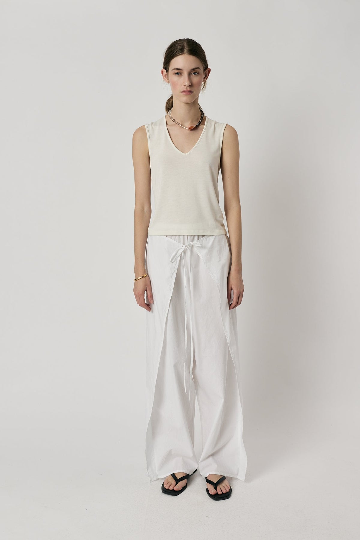 Image of a model wearing Pants. Product name - Giliann Luna Pant White in White colour by brand - Giliann