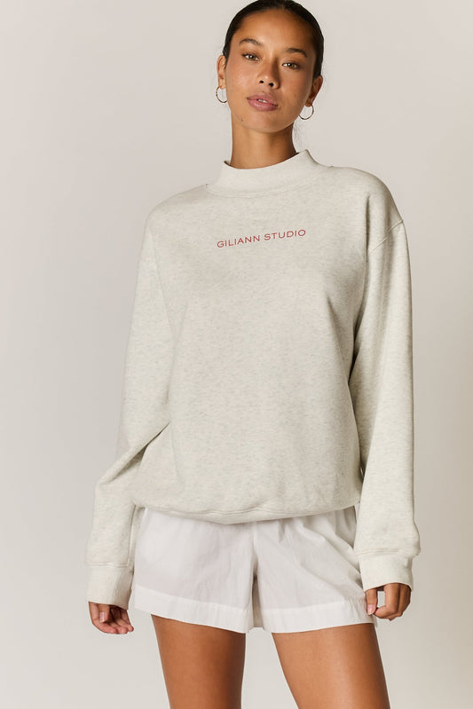 Image of a model wearing Outerwear. Product name - Giliann Logo Mockneck Pullover Grey in Grey colour by brand - Giliann