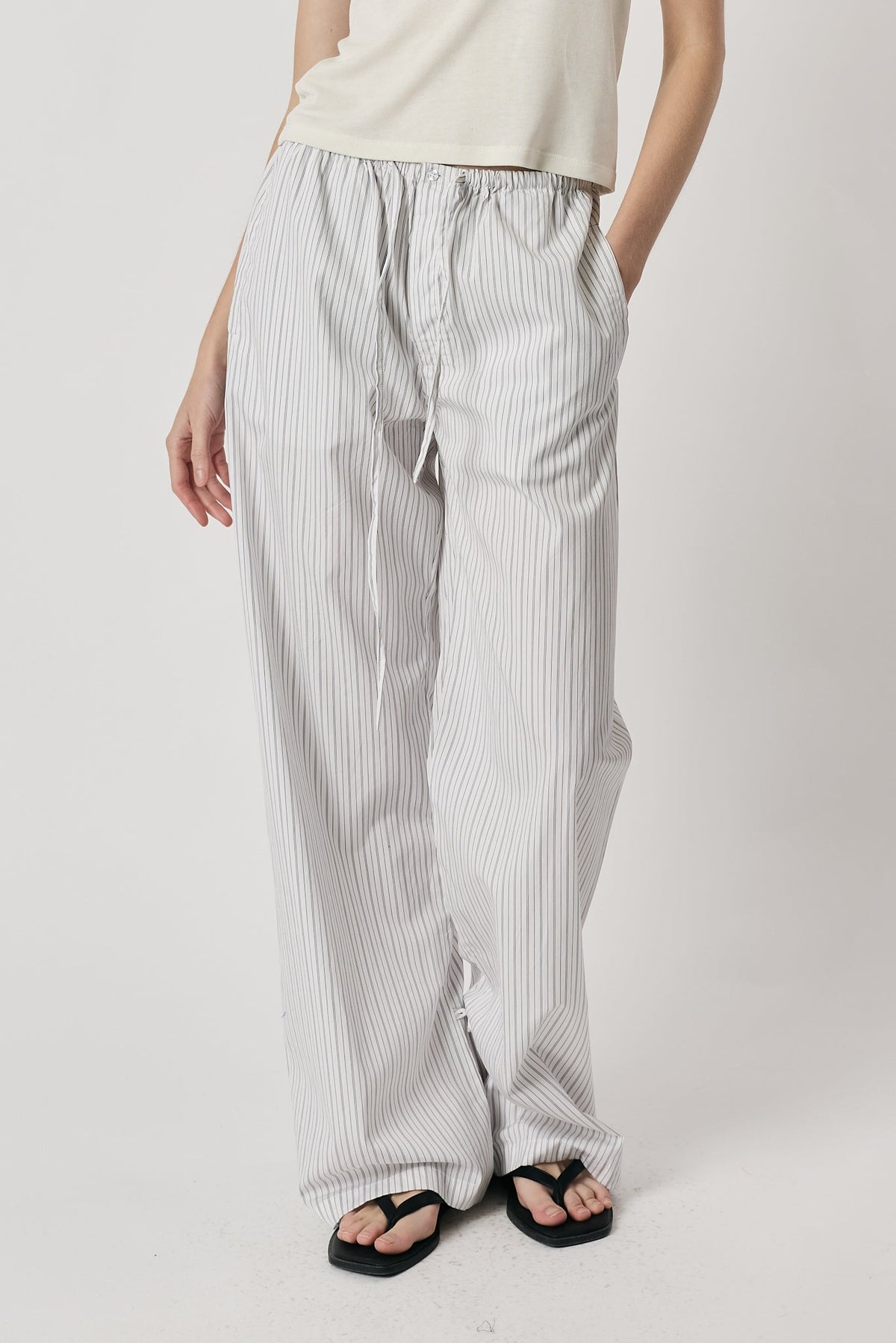Image of a model wearing Pants. Product name - Giliann Romy Pant Black/White Stripe in Black colour by brand - Giliann