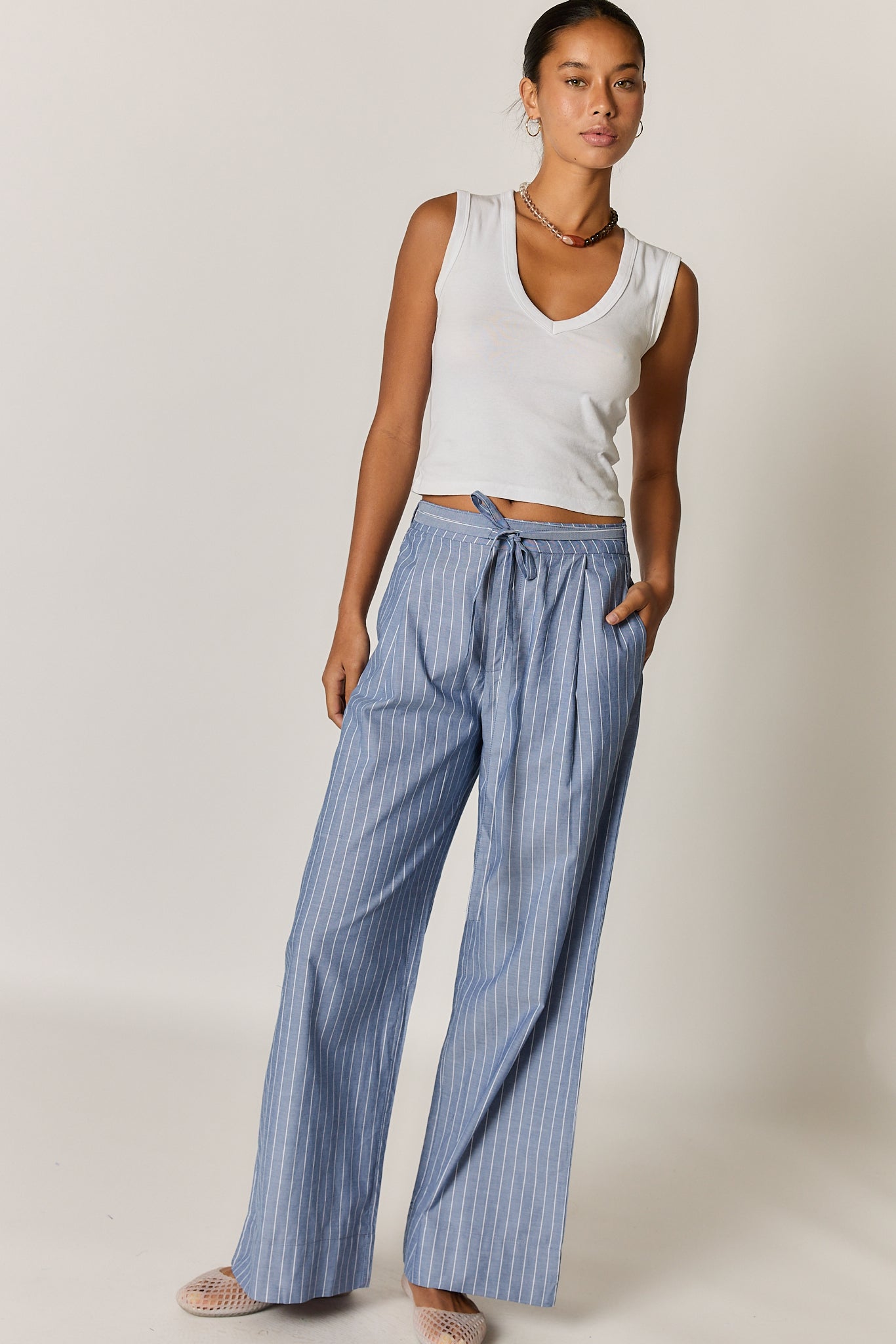 Image of a model wearing Pants. Product name - Giliann Floyd Tie Pant Blue Pin Stripe in Blue colour by brand - Giliann