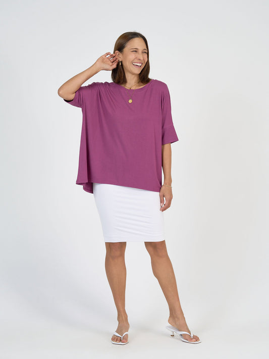 Image of a model wearing Tops. Product name - Gina Oversized Slouch Bamboo T-Shirt Plum in Plum colour by brand - Lou Lou
