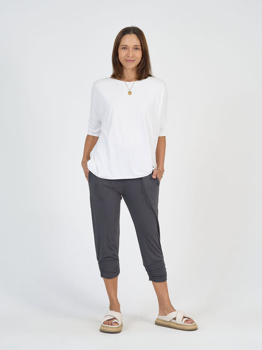 Image of a model wearing Tops. Product name - Gina Oversized Slouch Bamboo T-Shirt White in White colour by brand - Lou Lou
