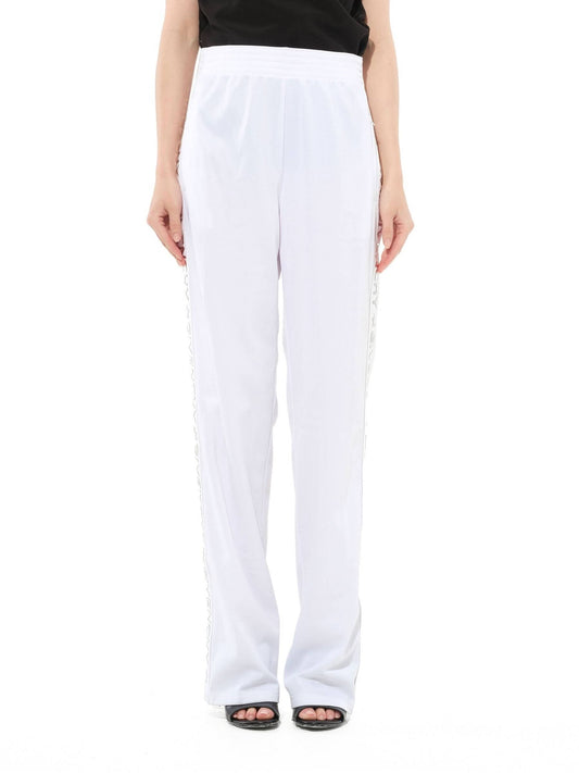 Image of a model wearing Pants. Productname: GIVENCHY Track Pants in White colour by brand - GIVENCHY